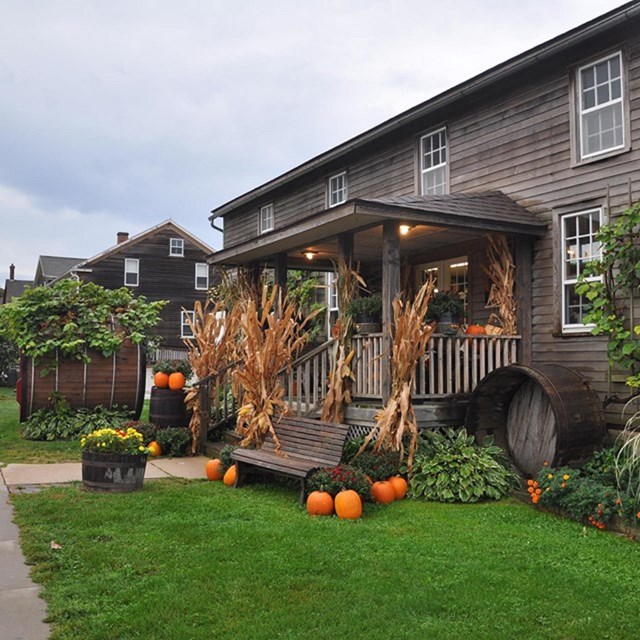 Historic buildings with fall decorations out front. 